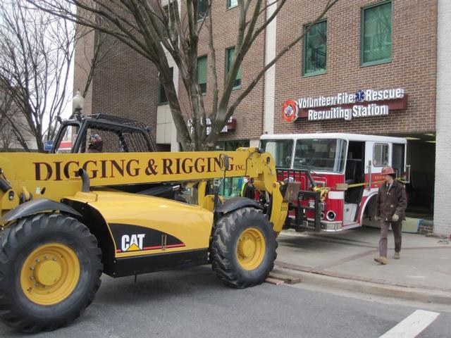 Digging and Rigging put the Fire Engine Cab in the new Recruitment Office right through the front door! all 6,000 lbs 